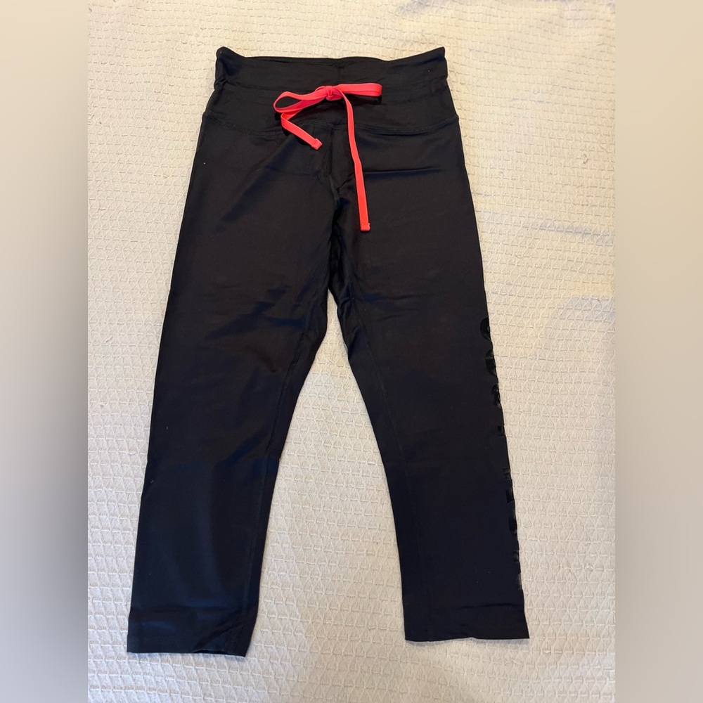 Woman’s Black Leggings with Hot Pink Jaw String and Mesh “Just Run” Cutout